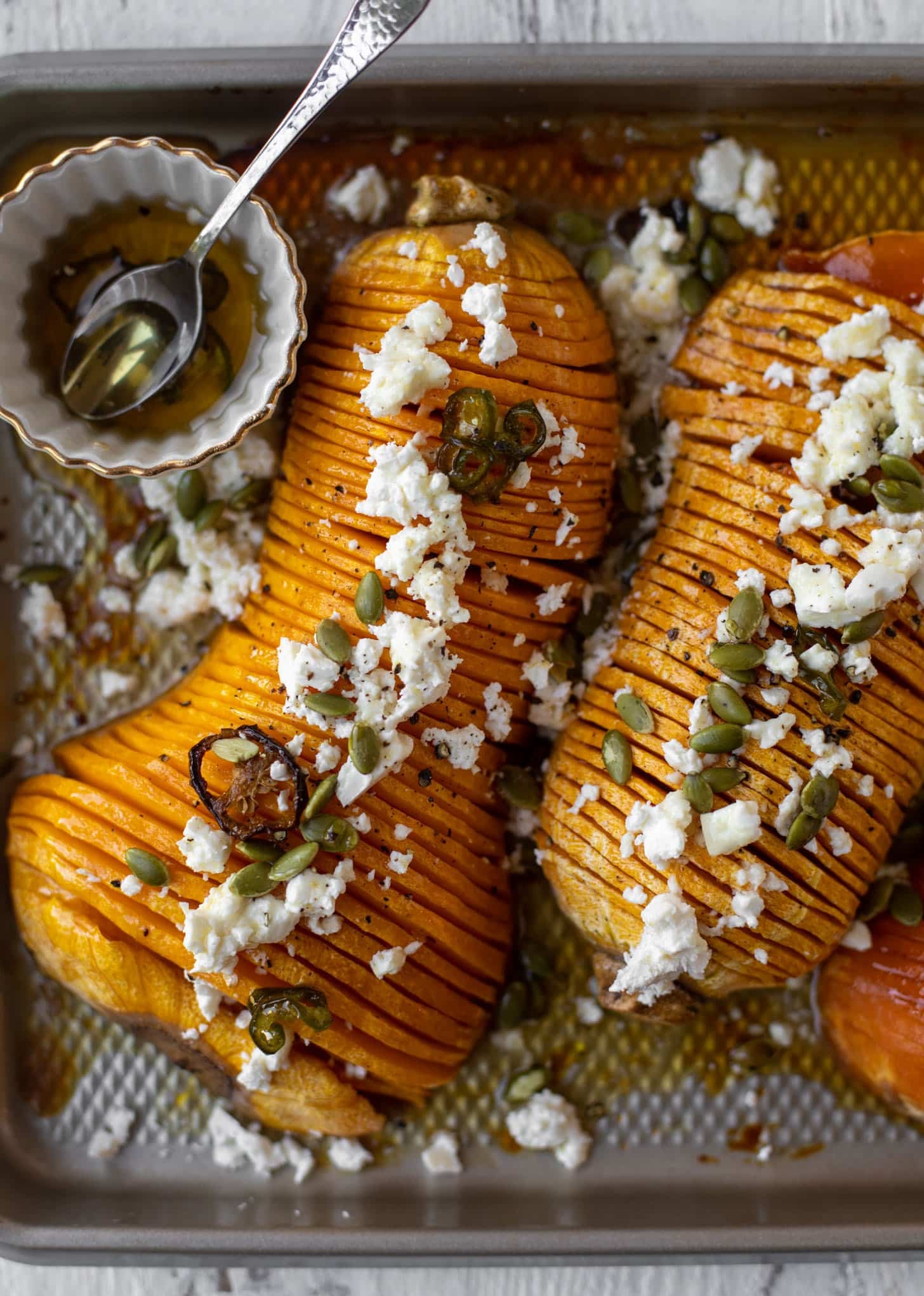 hot honey hasselback butternut squash with feta and pepitas