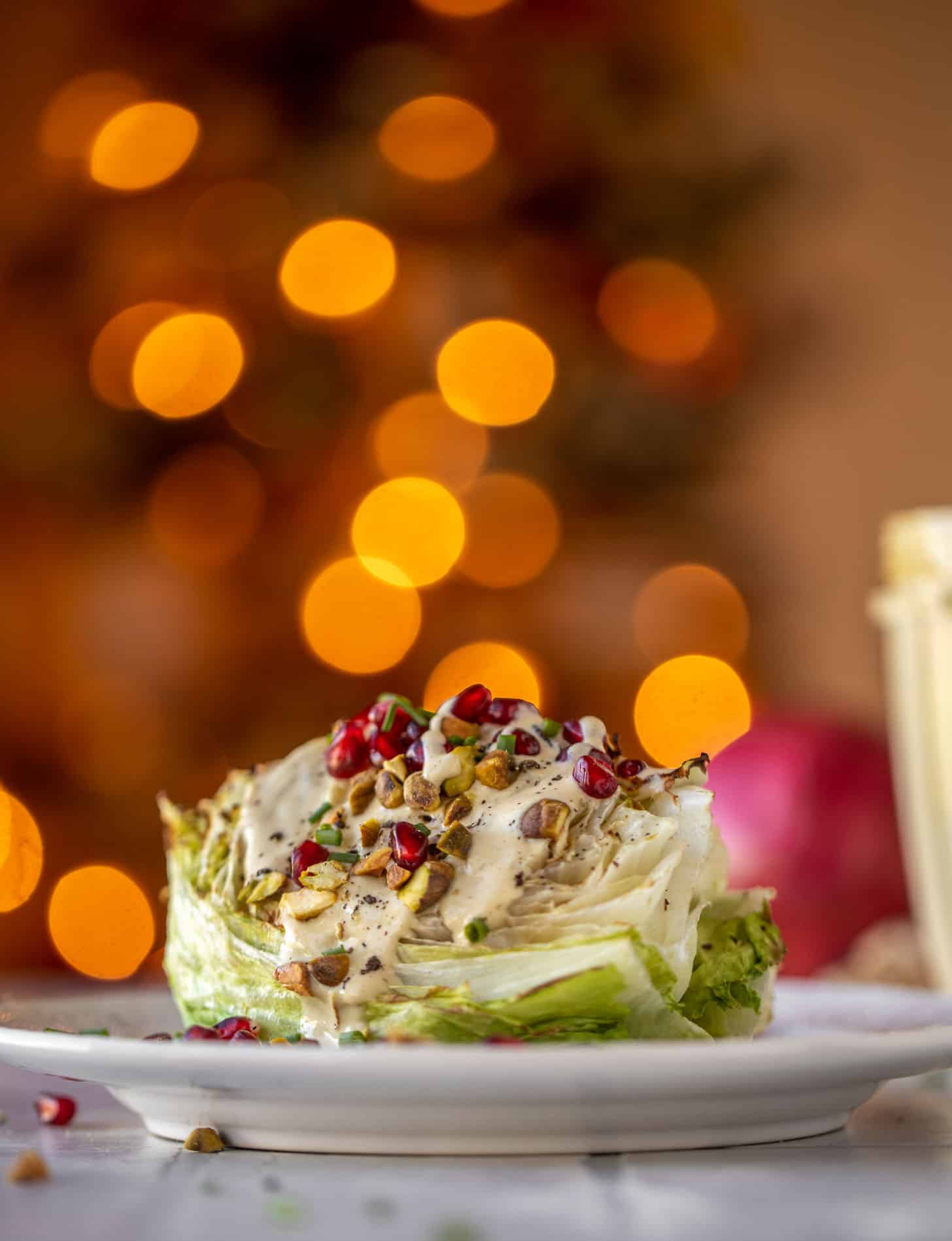 broiled wedge salad with pomegranates and pistachios