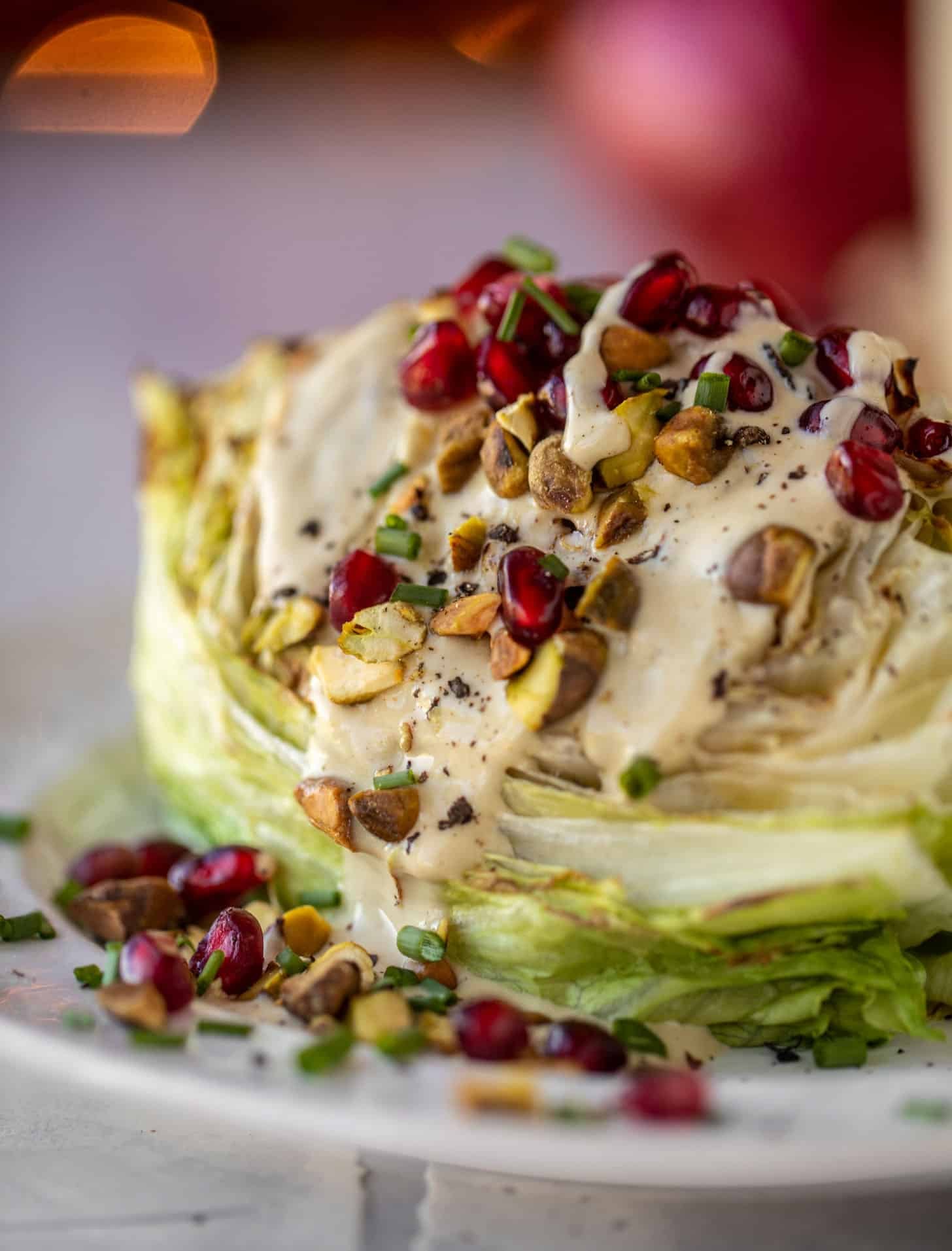 broiled wedge salad with pomegranates and pistachios
