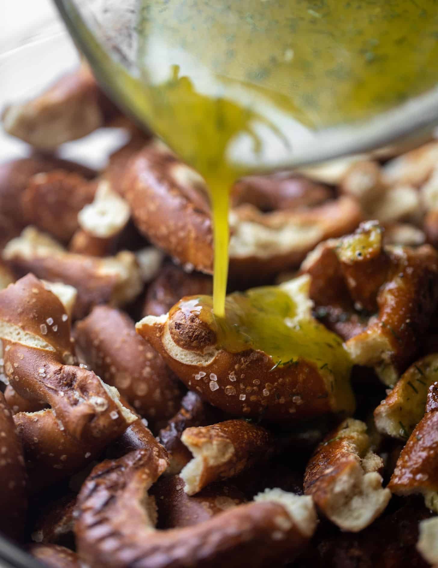 pouring seasoning on the pretzels