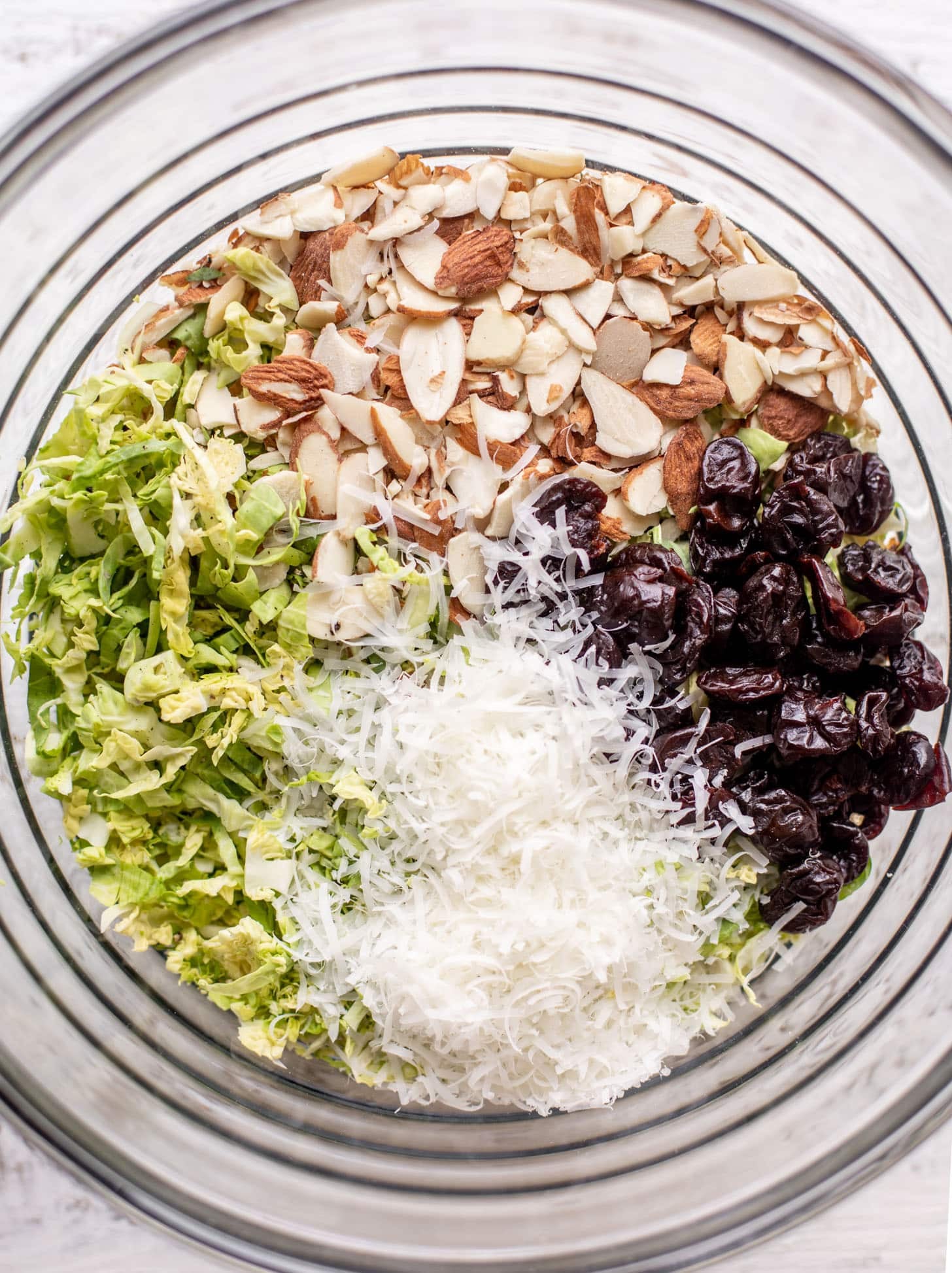 bowl of brussels sprouts, almonds, cheese and cherries