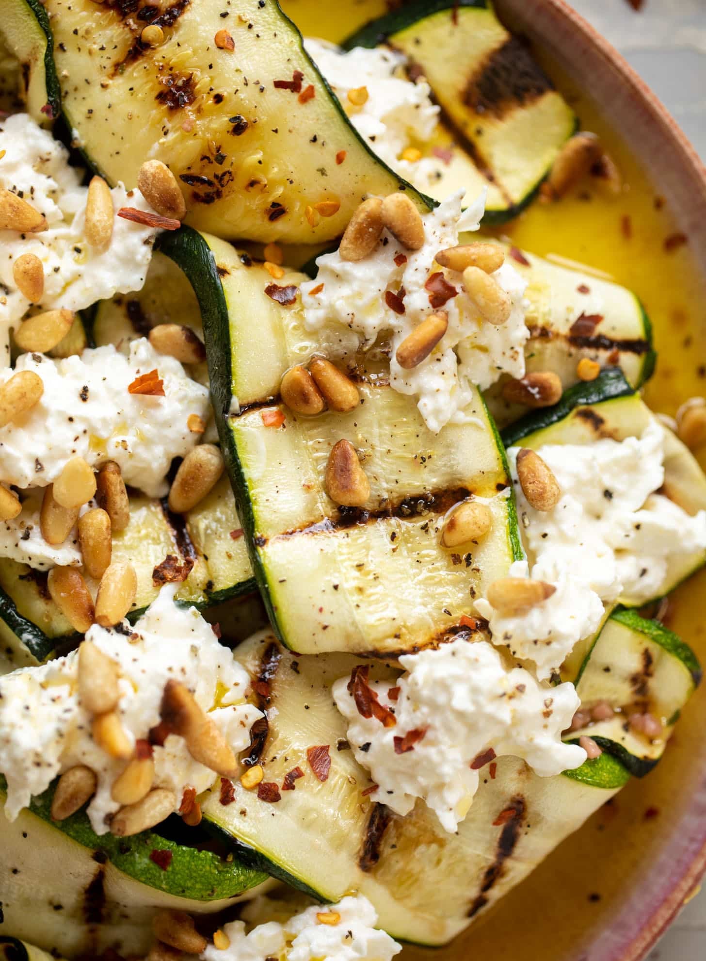 grilled zucchini with burrata and pine nuts