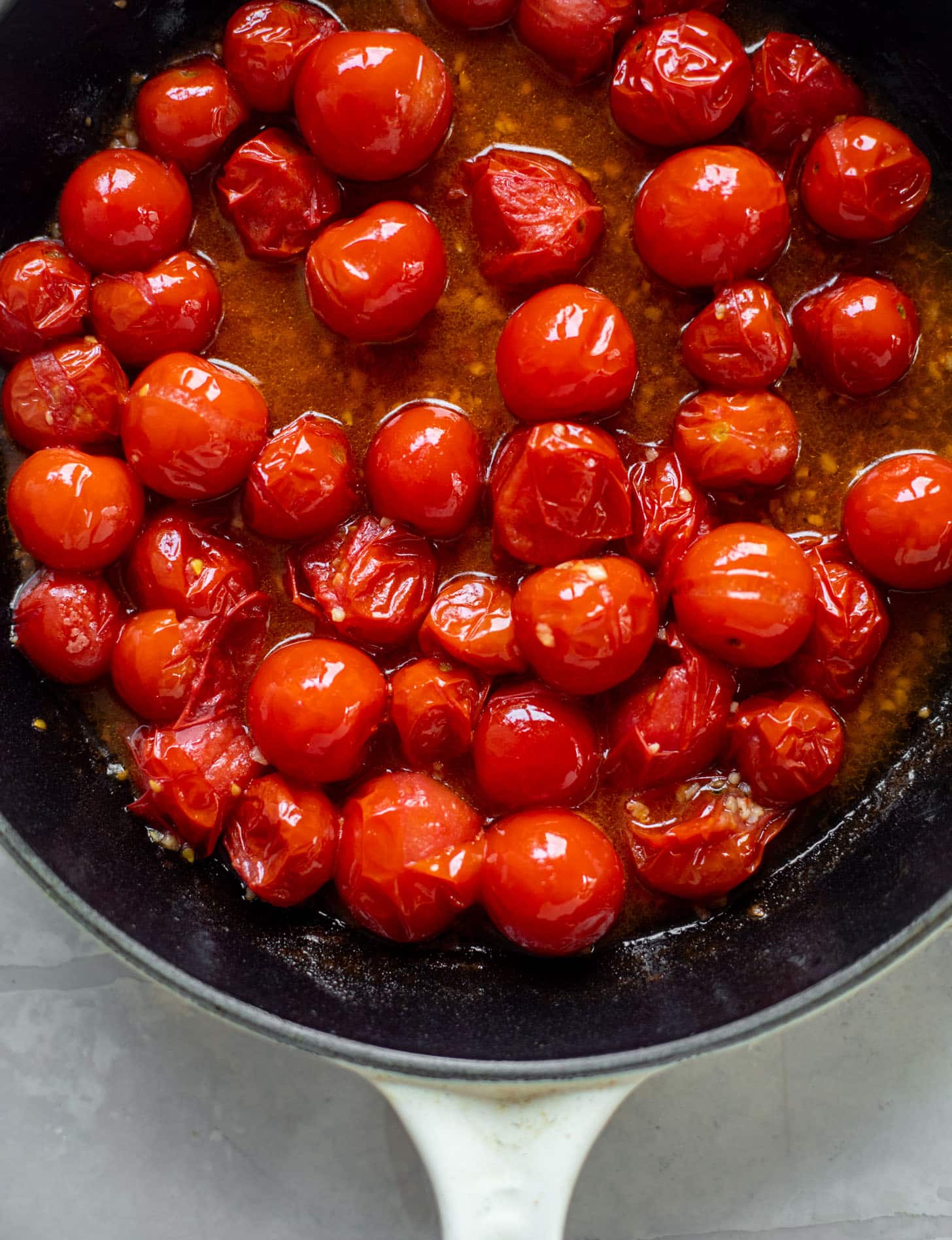 burst tomatoes in a skillet