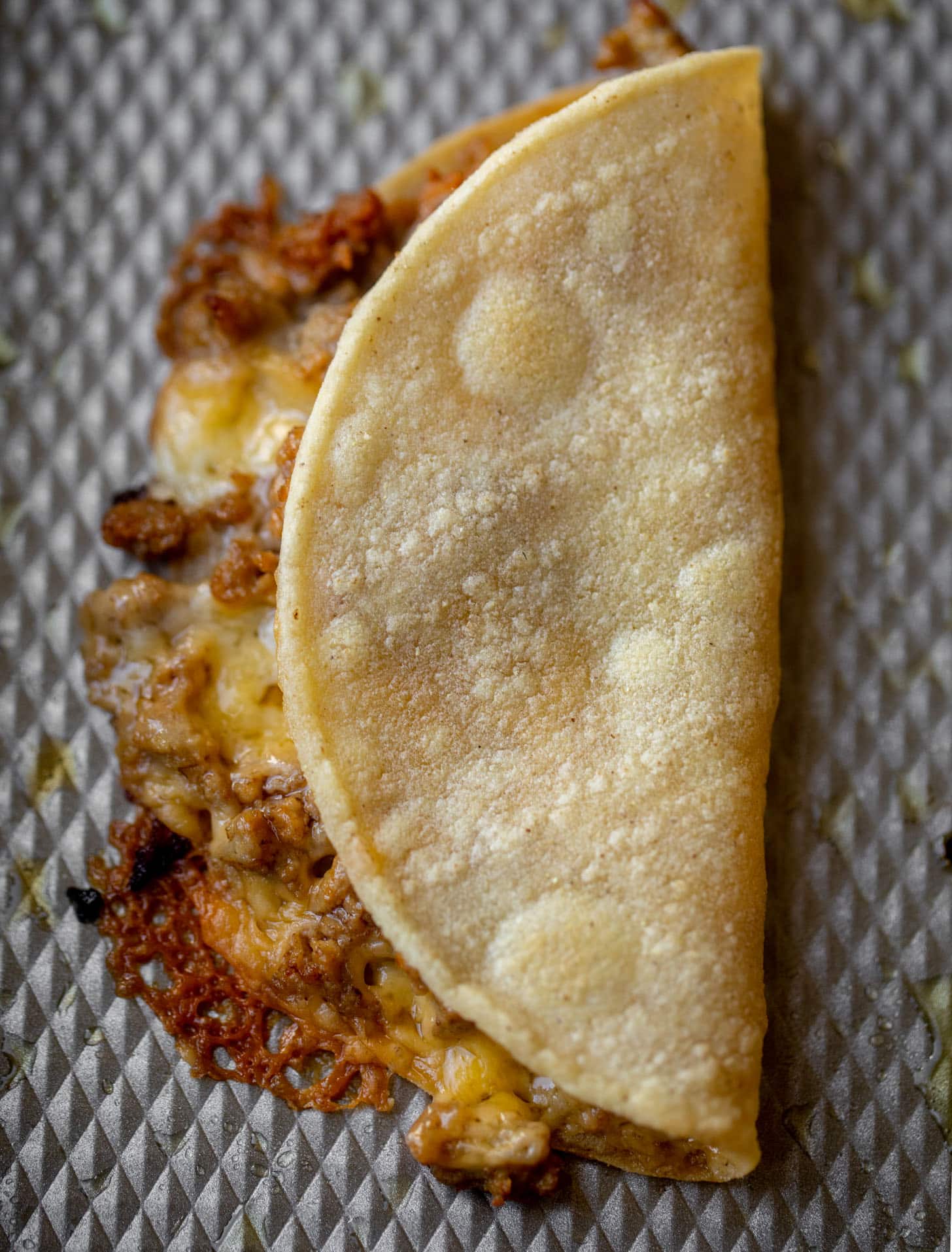 baked burger tortilla on a sheet pan