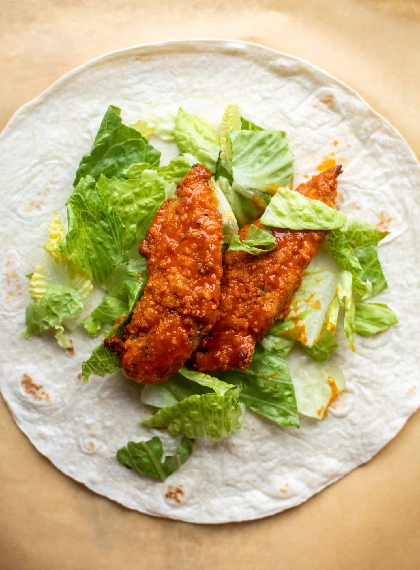 tortilla with lettuce and buffalo chicken