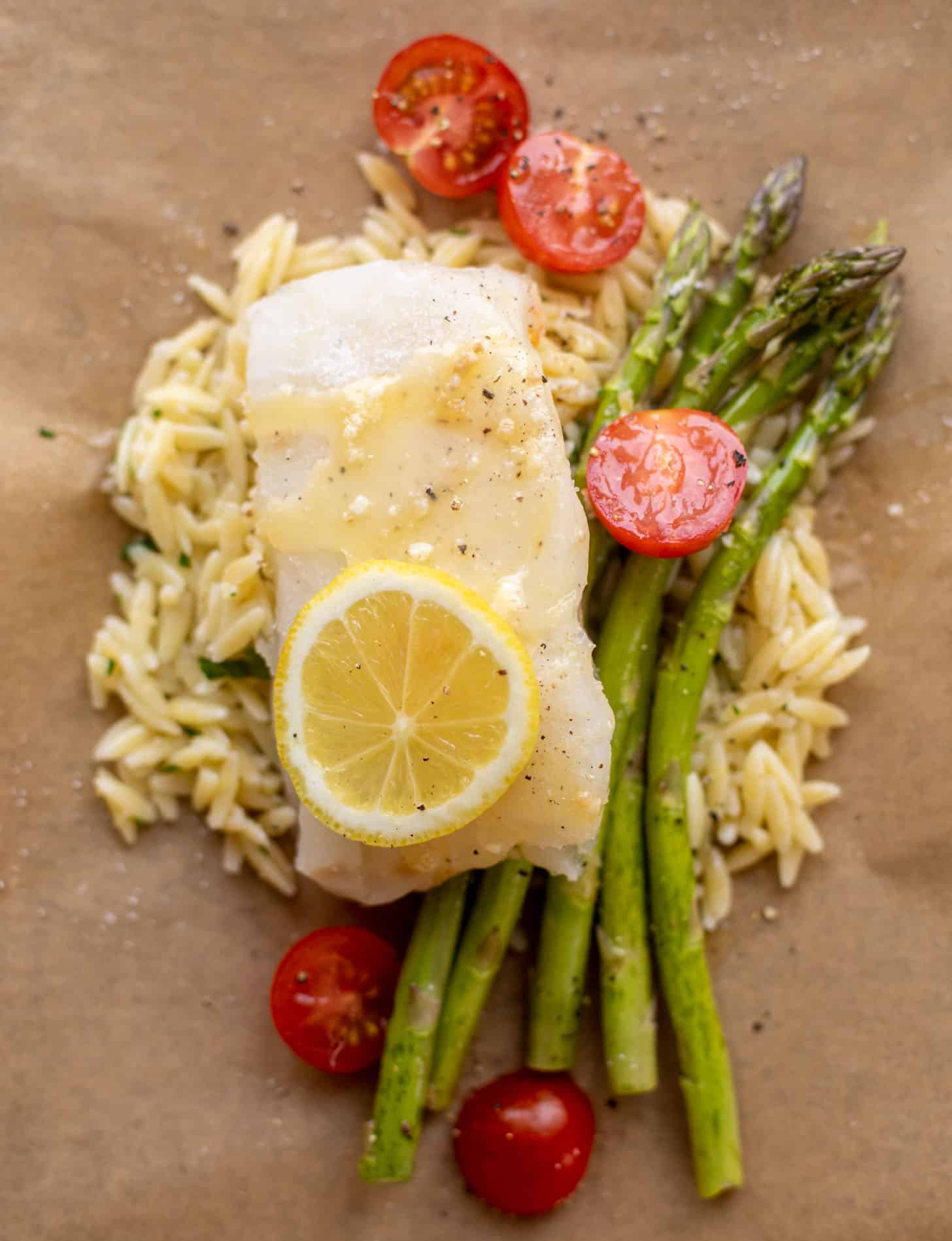 lemon garlic butter orzo and fish in parchment packet