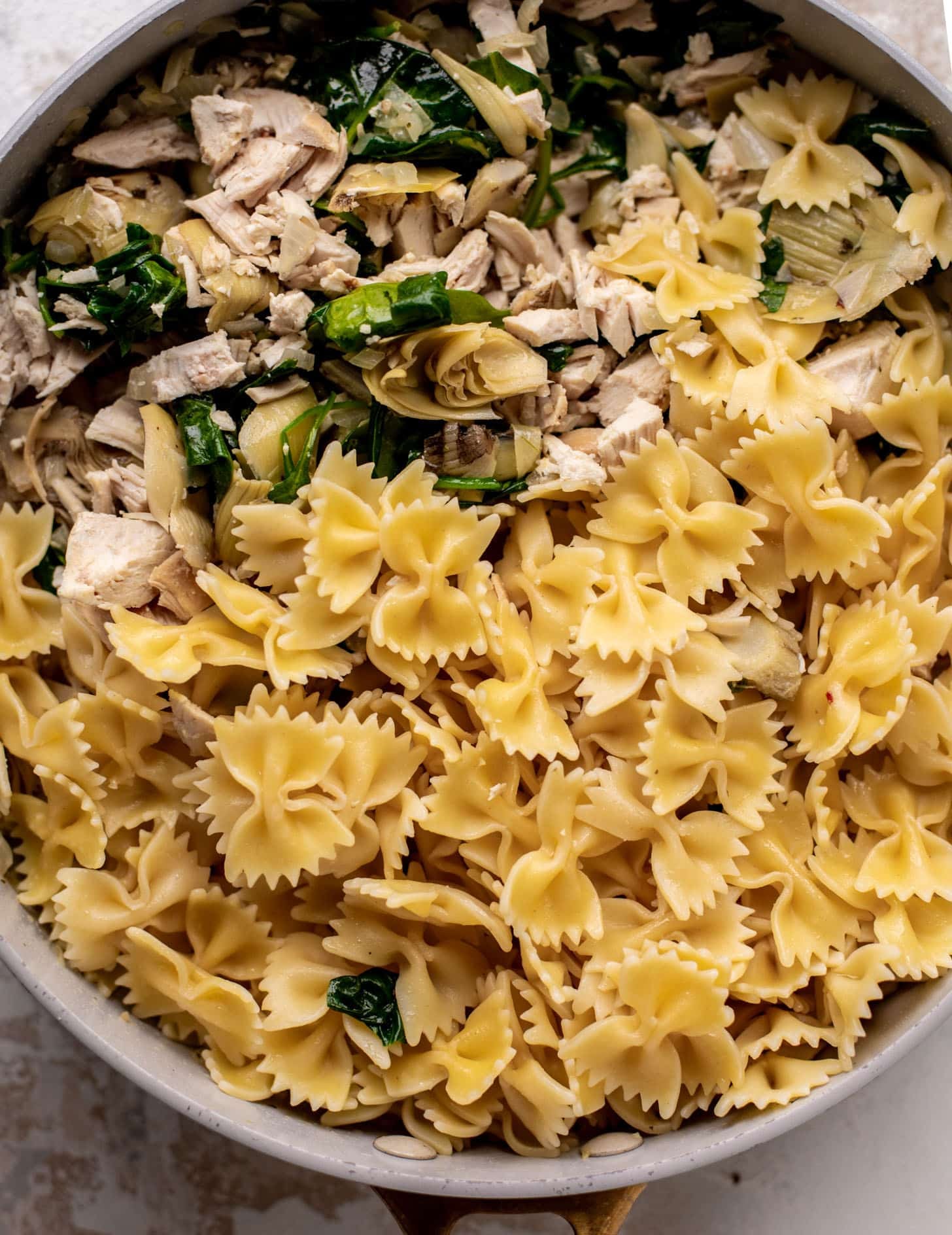 spinach artichoke chicken skillet lasagna ready for the oven