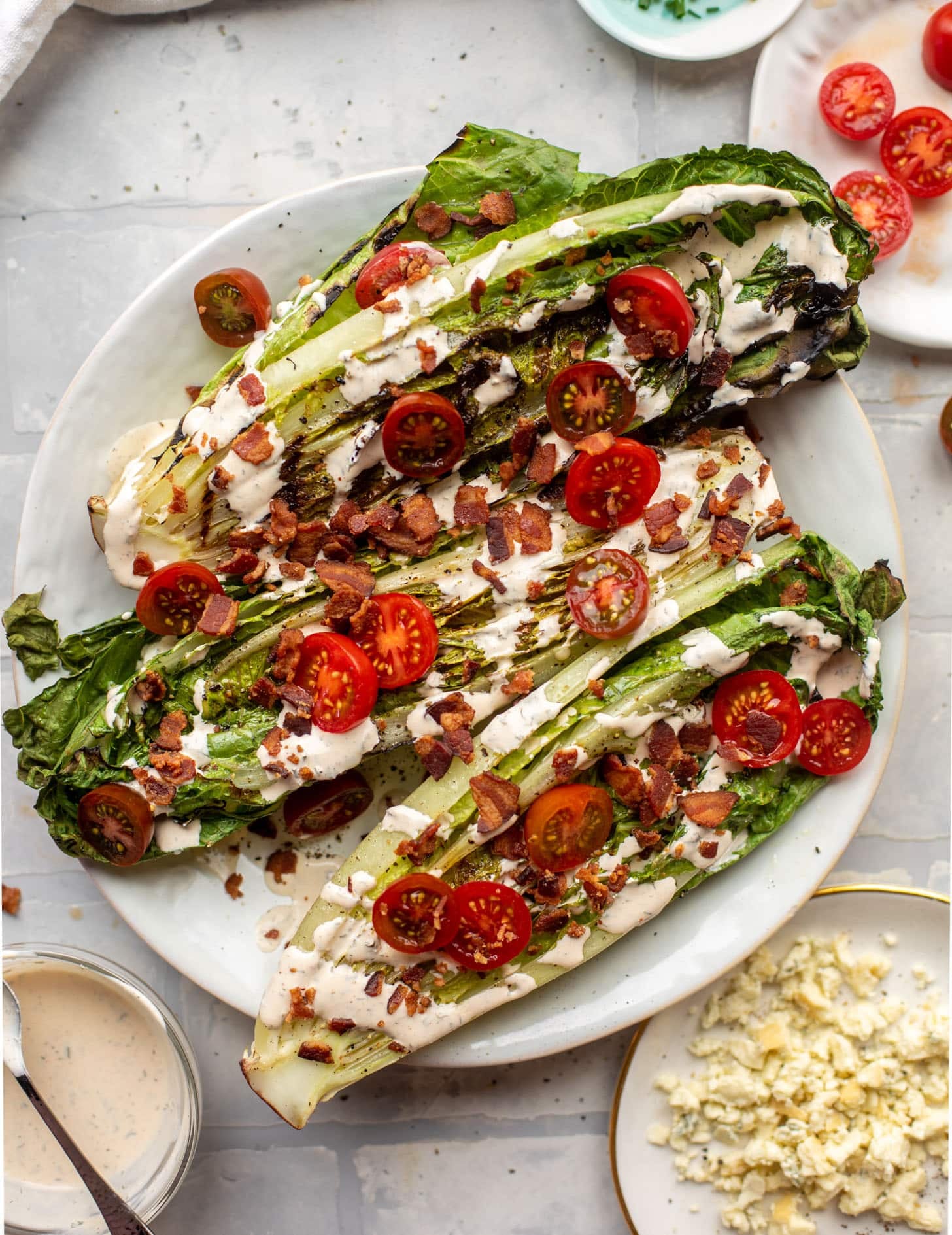 grilled romaine salads with tomatoes, bacon and ranch