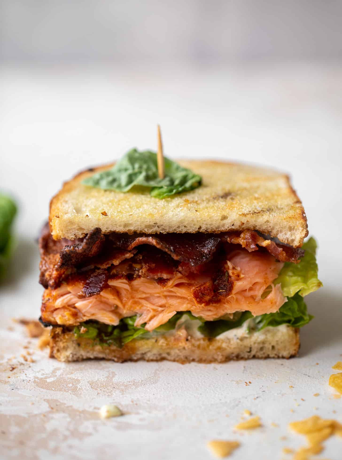 salmon club sandwich with charred scallion mayo