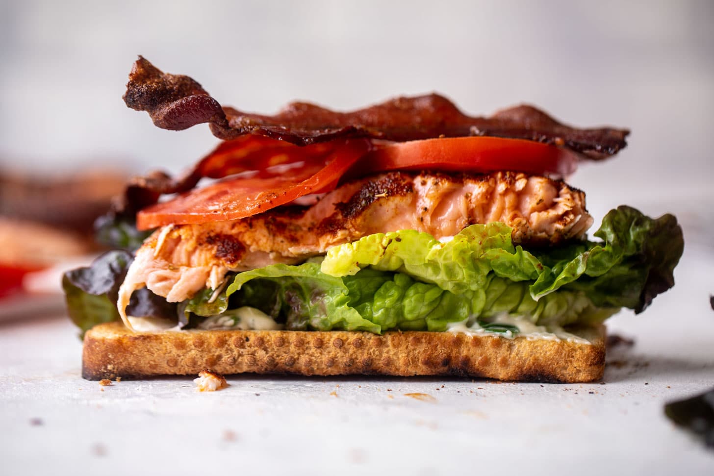 salmon club sandwich with charred scallion mayo
