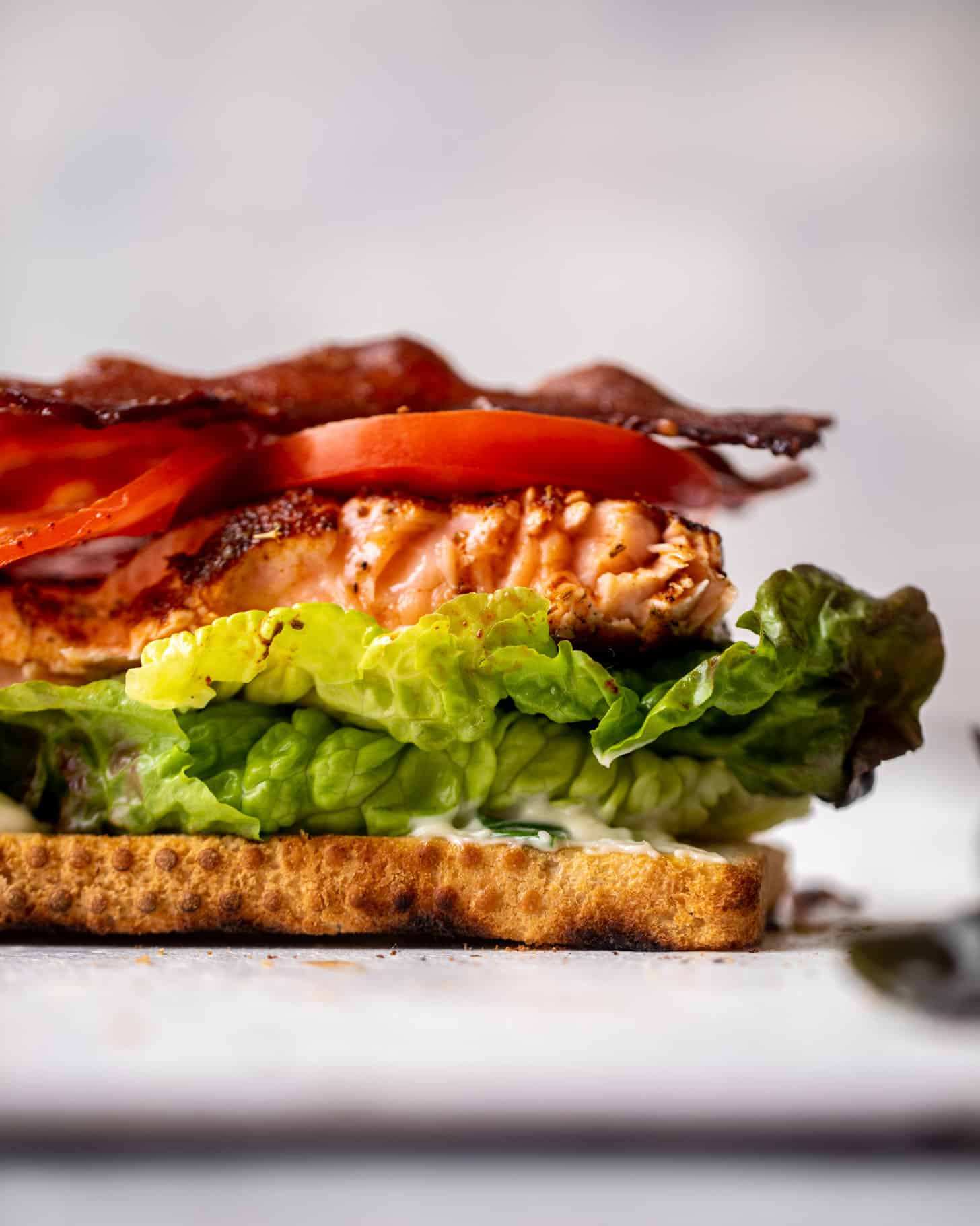 salmon club sandwich with charred scallion mayo