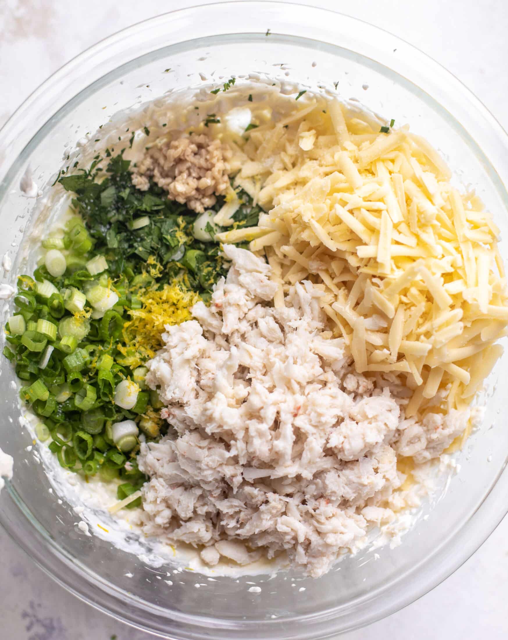 bowl of crab, herbs, scallions, cheese, lemon zest, garlic