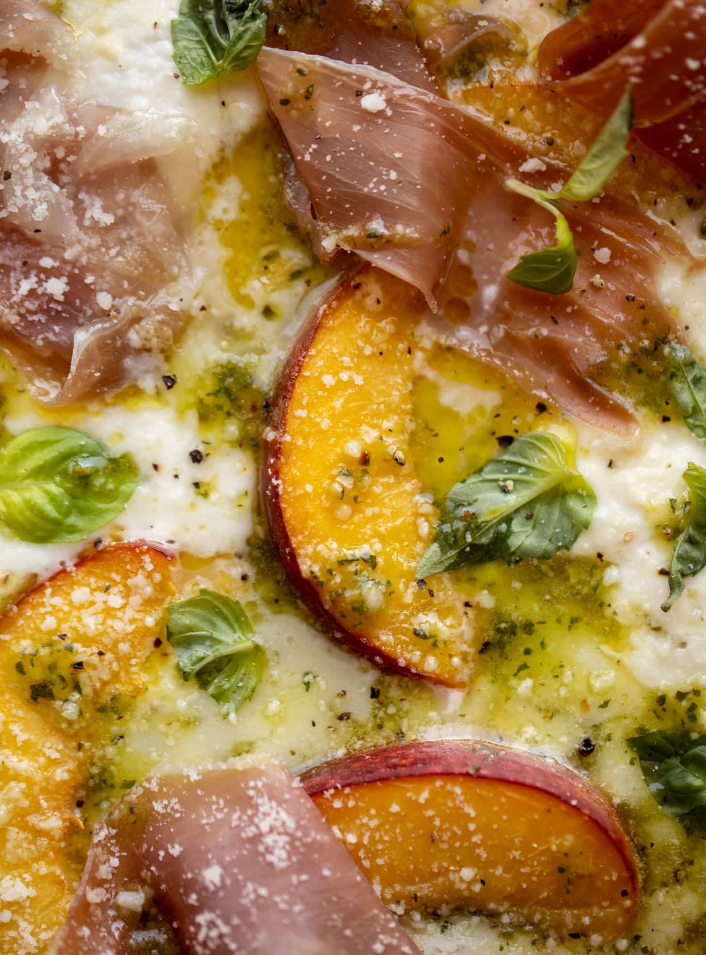 pesto peach pizza with prosciutto and burrata
