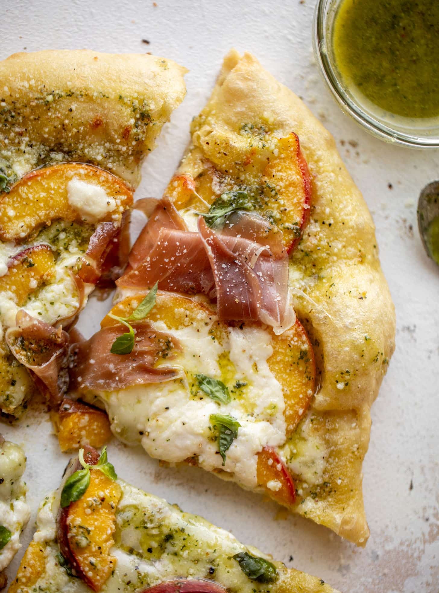 pesto peach pizza with prosciutto and burrata