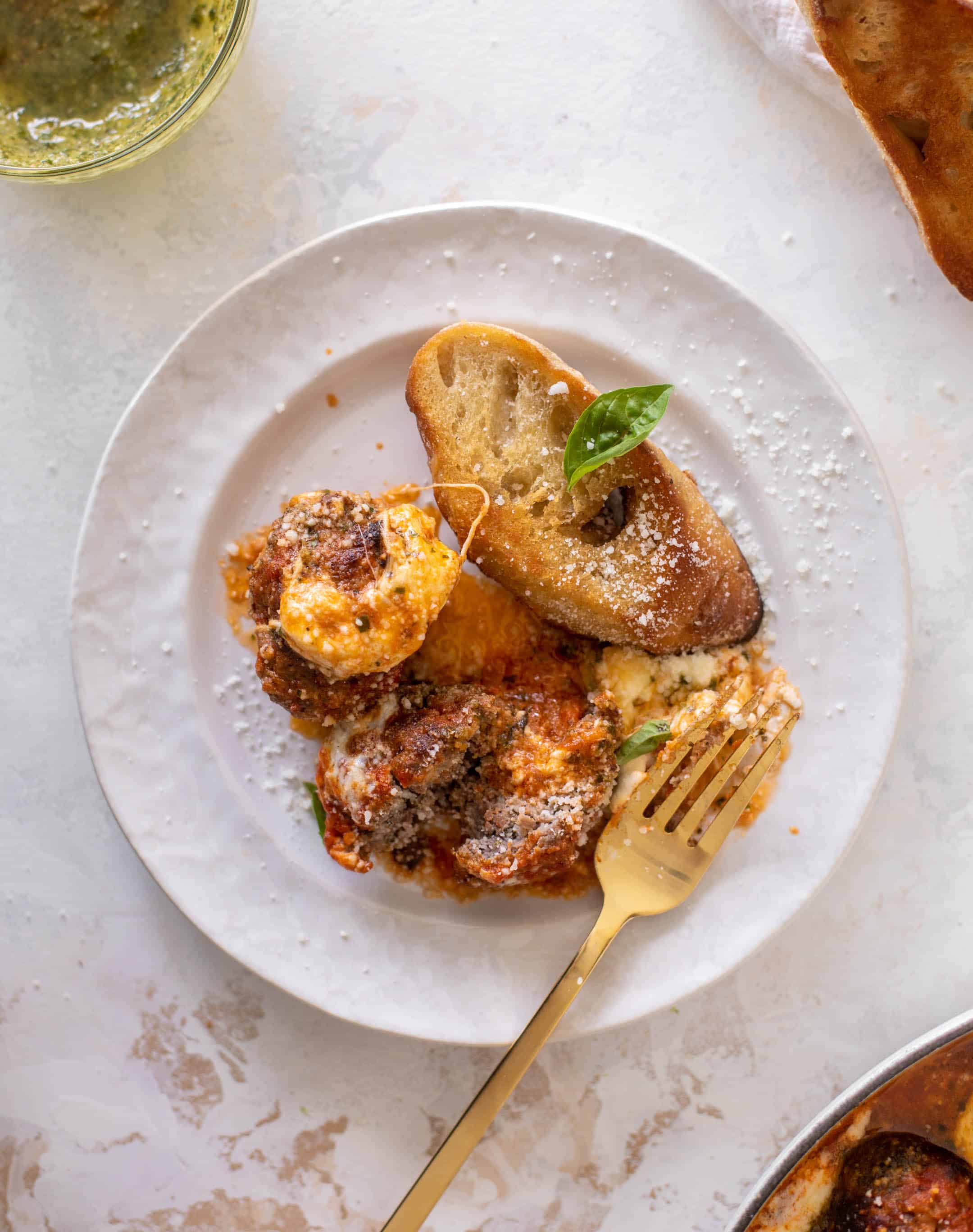 cheesy baked pesto meatballs with burrata