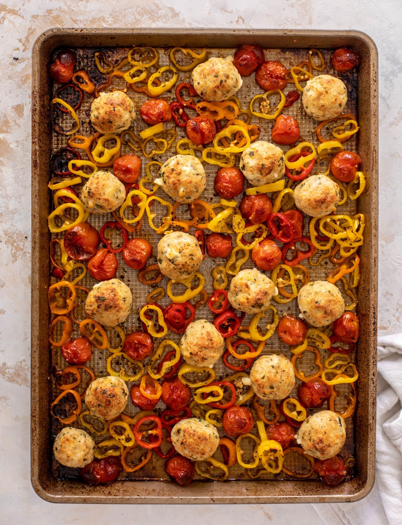 sheet pan chicken meatballs with tomatoes and feta
